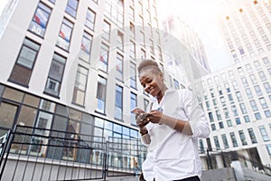 African american woman with backpack walking outdoor and talking on mobile phone