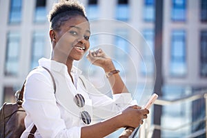 African american woman with backpack walking outdoor and talking on mobile phone