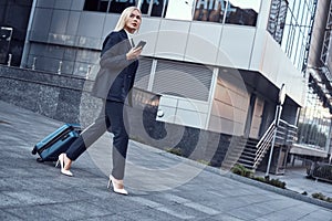 Travel, business trip. People and technology concept - happy young woman with suitcase