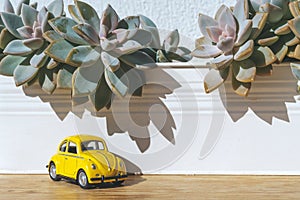 Travel car concept. Toy yellow car moves on against the backdrop of nature. Driving, adventure, discovery idea