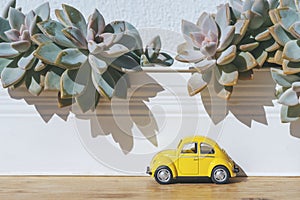 Travel car concept. Toy yellow car moves on against the backdrop of nature. Driving, adventure, discovery idea