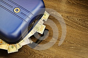 Travel case full of euro and us dollars banknotes, cash transaction or payment concept