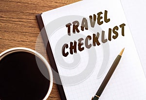 Travel Checklist write on a book on wooden desk