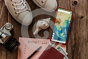 Travel concept banner flat lay.Items for summer vacation: passport,sneakers,money,smartphone with Asia map,retro camera copy space