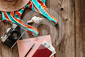 Travel concept banner flat lay.Items for summer vacation: passport,swimsuit,hat,money,vintage camera copy space.Top view holiday