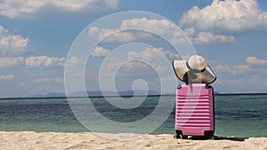 Travel concept with Banner of travel in Summer with Pink luggage on the sunny day as white sand Beach background