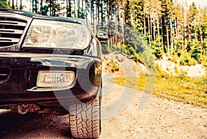 Travel concept with big car . Closeup photo of offroad wheel. Closeup of car wheel on steppe terrain. Off-road on