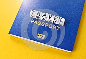 Travel concept with biometric international passport and cubes with word `Travel`