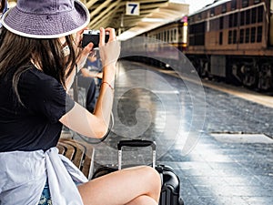 Travel concept.group of traveller friend take photo with train background.asia tourist feel happy in terminal at Hualumpong