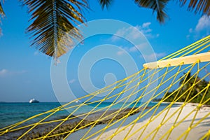 Travel concept with a hammock in a tropical beach