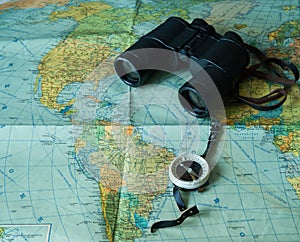 Travel concept  and holidays. Binoculars, map and compass.