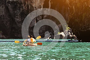 Travel concept with kayakers on sea bay backdrop