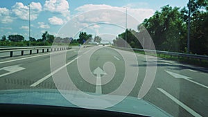 Travel concept. Landscape from a fast moving car. View from the car window to the roadside and fields on a summer or