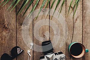 Travel concept, photo camera, cup of coffee, eyeglasses and earphones