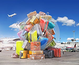 Travel concept. Pile of various styles of suitcases in airport