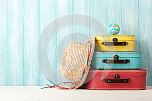 Travel concept with retro style suitcases, straw hat and globe o