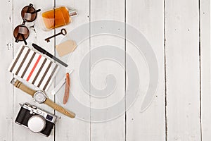 travel concept - set of cool stuff with camera and other things on wooden table