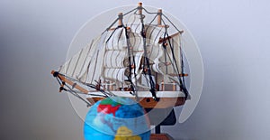 Travel Concept Stock Photo. Blurred Globe In Front Of Wooden Model Of Old Ship