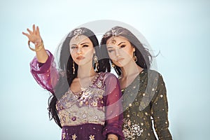 Travel concept. Two gordeous women sisters traveling in desert.