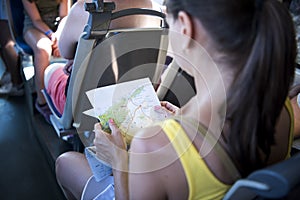 Travel concept. Woman read road map in public bus