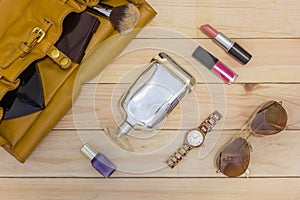 Travel concept - women set with bag, cosmetics, perfume, watch, Sunglasses on wooden background.