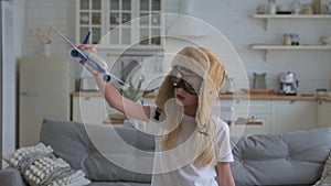 Travel conception. Girl imagines herself as an aircraft pilot child`s desire fly high in sky. Cute blonde caucasian girl