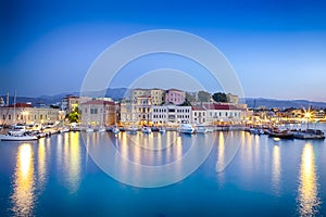 Travel Concepts. Picturesque Image of Old Venetian Harbour of Chania with Fisihing Boats and Yachts on the Foregound Taken At Blue