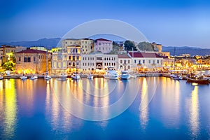 Travel Concepts. Picturesque Image of Old Venetian Harbour of Chania with Fisihing Boats and Yachts on the Foregound Taken At Blue