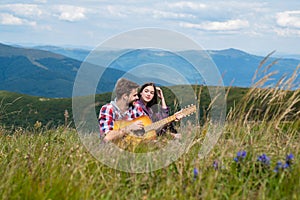 Travel couple enjoying wanderlust view, friends excitement at mountain background.