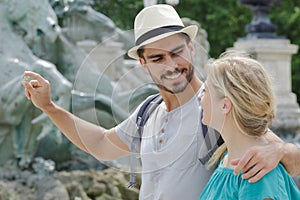 travel couple trowing coin at trevi fountain
