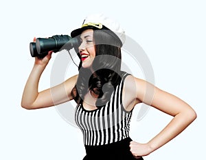 Travel, cruise, people concept - pretty smiling woman brunette sailor looking through binoculars