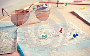 Travel destination points on a map and sunglasses