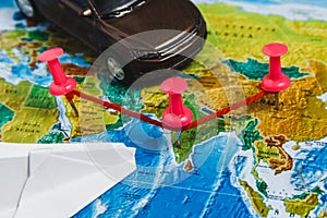 Travel Destination Points on World Map Indicated with Colorful Thumbtacks, Rope and Shallow Depth of Field.