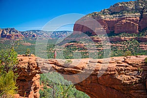 Travel in Devil's Bridge Trail, scenic view panoramic landscape in Sedona, Arizona, USA. Happy young woman on the