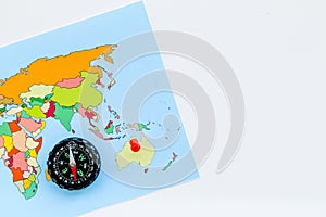 Travel direction and trip planning concept with compass and map of the world on white background top view mock up