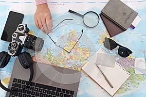 Travel Essentials. Overhead view of travel items on a map.
