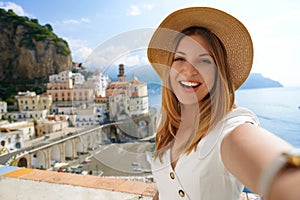 Travel in Europe. Selfie woman on Amalfi Coast, Italy. Happy laughing tourist girl taking self-portrait picture with smartphone