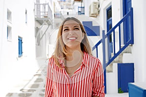 Travel in Europe for summer holiday. Portrait of beautiful woman visiting old village in Greece