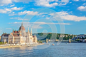 Travel and european tourism concept. Parliament and riverside in Budapest Hungary with sightseeing ships during summer sunny day