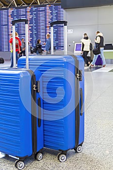 Travel Fashion. Closeup Shot Of Two Plastic Suitcases Standing At Airport , Stylish Luggage Bags Waiting At Terminal