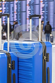 Travel Fashion. Closeup Shot Of Two Plastic Suitcases Standing At Airport , Stylish Luggage Bags Waiting At Terminal
