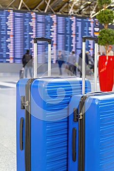 Travel Fashion. Closeup Shot Of Two Plastic Suitcases Standing At Airport , Stylish Luggage Bags Waiting At Terminal