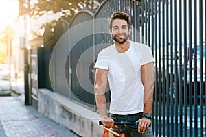 Travel, fashion and portrait of man with bicycle in city for sightseeing on vacation, holiday or adventure. Smile