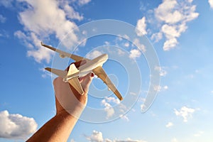 Travel and flight concept, airplane model in a man`s hand. Travel photography motivator for vacation