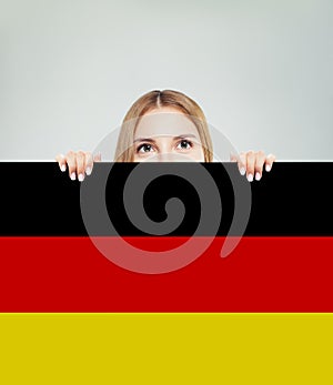 Travel in Germany concept. Pretty woman showing Germany flag