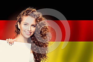 Travel in Germany concept. Pretty woman showing white background against the Germany flag background