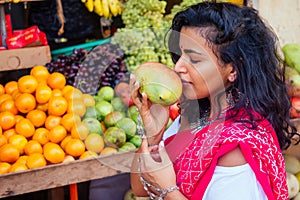 Travel girl seller in street market and a buyer in a fruit shop in india