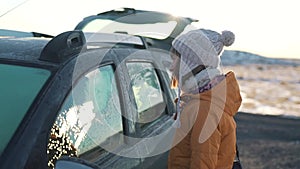 Travel girl stands near car