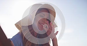 Travel, hat and happy woman in chair on beach for summer vacation, outdoor sunshine and tropical island. Relax, journey