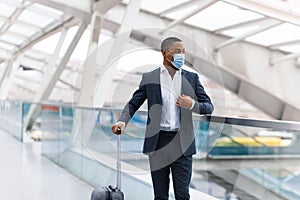 Travel Health Insurance. Black Businessman Wearing Medical Mask Standing In Airport